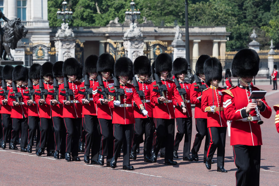 Members of the Household Division Foot Guards march along The Mall