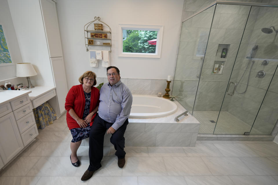 Gene and Sallie Carr pose for a picture in their recently remodeled home on Tuesday, May 7, 2024, in Hendersonville, N.C. An increasing number of Americans in their late 50s and older are staying in their houses, some by choice, others because they're locked into low mortgage rates that are too low to give up. (AP Photo/Chris Carlson)