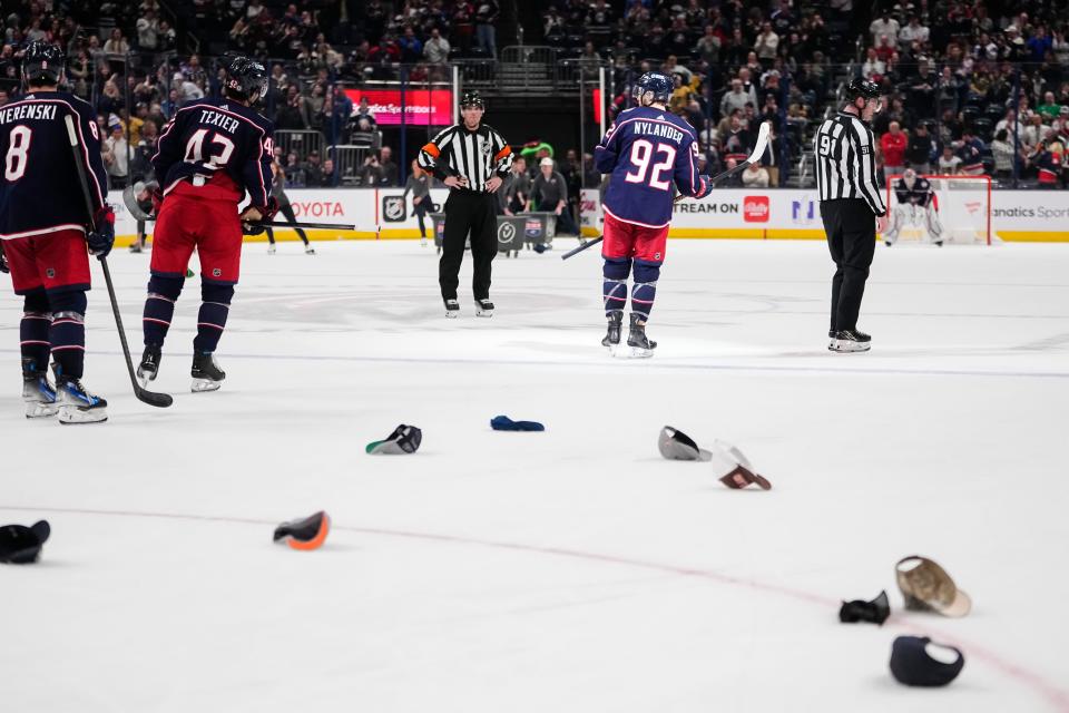 Mar 4, 2024; Columbus, Ohio, USA; Hats rain onto the ice after a hat trick by Columbus Blue Jackets left wing Alexander Nylander (92) during the third period of the NHL hockey game against the Vegas Golden Knights at Nationwide Arena. The Blue Jackets won 6-3.