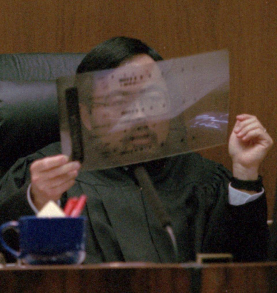 <p>Judge Lance Ito holds up a sample of a DNA sequence during the trial. The prosecution built its case largely around DNA evidence they said linked O.J. Simpson to the crime scene. But the defense raised questions about the reliability of the blood evidence; arguing it had been mishandled by police. (Photo: John McCoy/AP) </p>