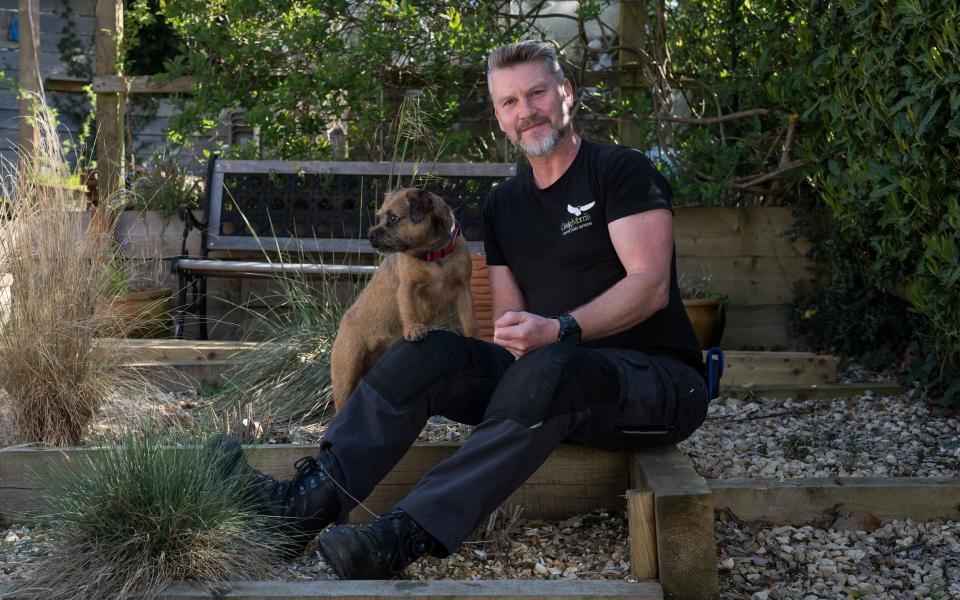 Pest controller Craig Morris and his dog Monty the terrier in Hampshire - Christopher Pledger