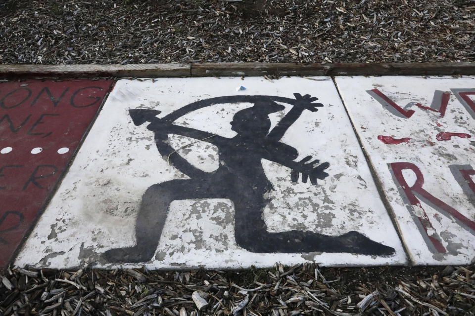 Native American imagery is painted along a walkway which leads from the Bountiful High School parking lot up to the football field Tuesday, July 28, 2020, in Bountiful, Utah. While advocates have made strides in getting Native American symbols and names changed in sports, they say there's still work to do mainly at the high school level, where mascots like Braves, Indians, Warriors, Chiefs and Redskins persist. (AP Photo/Rick Bowmer)