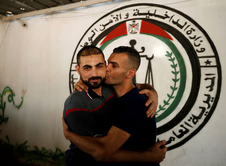 A member of Fatah movement is hugged and kissed upon his release from a Hamas-run jail as part of reconciliation efforts, in Gaza City October 1, 2017. REUTERS/Mohammed Salem