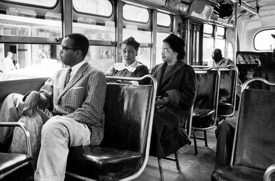 Montgomery Bus Boycotts: Rosa Parks (R) riding on newly integrated bus following Supreme Court ruling ending successful 381 day boycott of segregated buses.