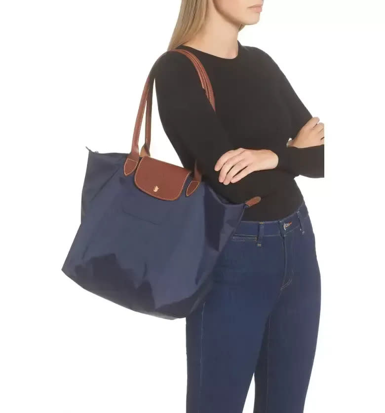 <div><p>"My favorite travel bag is the Le Pliage Tote by Longchamp. It has been me go to bag for minimalist travel for almost a decade. I love that the body is made of nylon and the straps are leather so it’s both incredibly durable yet stylish at the same time! It is a classic and simple bag with one interior pocket that forces you to be intentional about what you want to bring with you. I use smaller pouches to divide my things into categories and I bring a simple capsule wardrobe to keep my clothing items to a minimum. But you actually can squeeze a lot into the bag if needed! I am able to pack for an entire week easily and include my laptop, too, if it is a work trip. I just returned from a solo 3-week trip to Europe and there is no way I would’ve enjoyed moving around six different countries if I had tons of luggage with me. I get in and out of the airport quickly because I never have to wait at baggage claim. I hop off the flight and hit the ground running. — <a href="https://www.youtube.com/watch?v=ErPwLwccbDc" rel="nofollow noopener" target="_blank" data-ylk="slk:Carla;elm:context_link;itc:0;sec:content-canvas" class="link ">Carla</a> of The Carla Project, minimal lifestyle vlogger</p><p><a href="https://click.linksynergy.com/deeplink?id=yPKHhJU2qBg&mid=1237&u1=CarryOnTravelBags-UciliaWang-12-15-22-6896599&murl=https%3A%2F%2Fwww.nordstrom.com%2Fs%2Flarge-le-pliage-shoulder-tote%2F6862467" rel="nofollow noopener" target="_blank" data-ylk="slk:$124 at Nordstrom;elm:context_link;itc:0;sec:content-canvas" class="link "><i>$124 at Nordstrom</i></a></p><p><a href="https://www.amazon.com/Longchamp-Pliage-Large-Shoulder-Tote/dp/B0043IY2V8" rel="nofollow noopener" target="_blank" data-ylk="slk:$155 - $235 at Amazon;elm:context_link;itc:0;sec:content-canvas" class="link "><i>$155 - $235 at Amazon</i></a></p></div><span> Nordstrom</span>