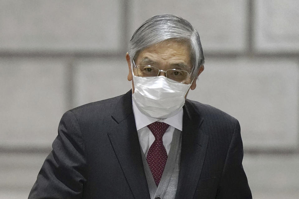 Bank of Japan Gov. Haruhiko Kuroda arrives for a meeting at the BOJ headquarters in Tokyo Wednesday, Jan. 18, 2023. Asian shares were mostly lower Wednesday after Japan’s central bank kept its lax monetary policy unchanged, contrary to speculation it would yield to pressure to tighten credit to counter rising inflation. (Kyodo News via AP)