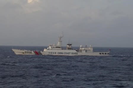 China Coast Guard vessel No. 31239 sails in the East China Sea near the disputed isles known as Senkaku isles in Japan and Diaoyu islands in China, in this handout photo taken and released by the 11th Regional Coast Guard Headquarters-Japan Coast Guard December 22, 2015. REUTERS/11th Regional Coast Guard Headquarters-Japan Coast Guard/Handout via Reuters