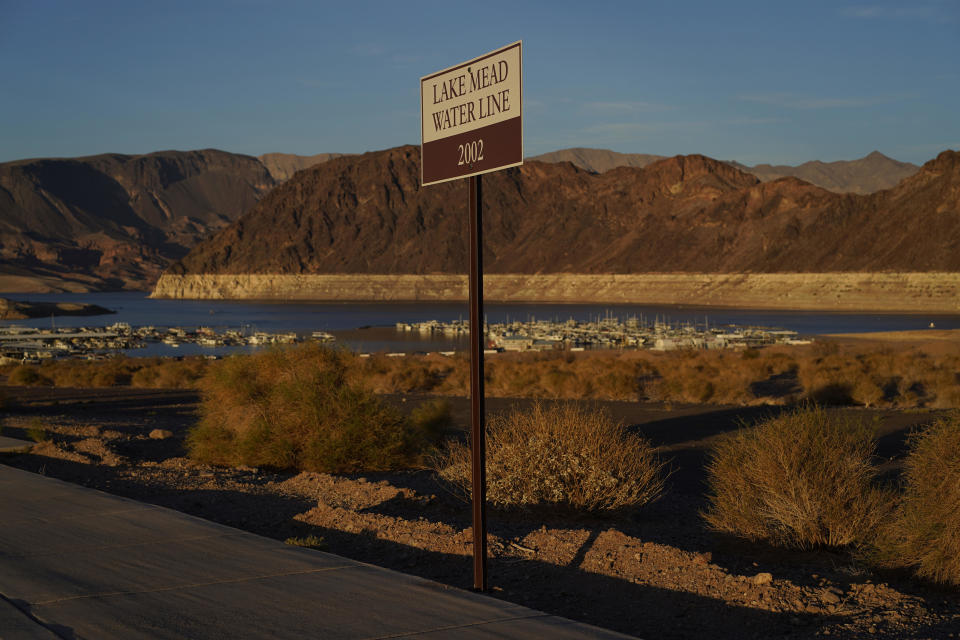 A sign marks the water line from 2002 near Lake Mead at the Lake Mead National Recreation Area, Saturday, July 9, 2022, near Boulder City, Nev. The largest U.S. reservoir has shrunken to a record low amid a punishing drought. / Credit: John Locher / AP