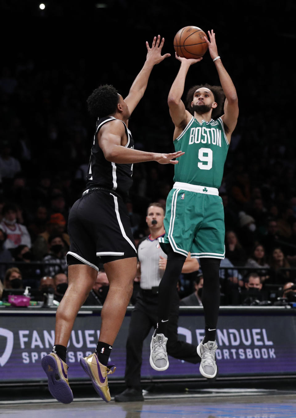 Boston Celtics guard Derrick White (9) shoots over Brooklyn Nets guard Cam Thomas (24) during the first half of an NBA basketball game Thursday, Feb. 24, 2022, in New York. (AP Photo/Noah K. Murray)