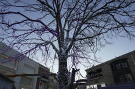 A worker puts up festive lights at a mall with shops re-opening for business as restrictions are eased in Beijing, Saturday, Dec. 3, 2022. Chinese authorities on Saturday announced a further easing of COVID-19 curbs with major cities such as Shenzhen and Beijing no longer requiring negative tests to take public transport. (AP Photo/Ng Han Guan)