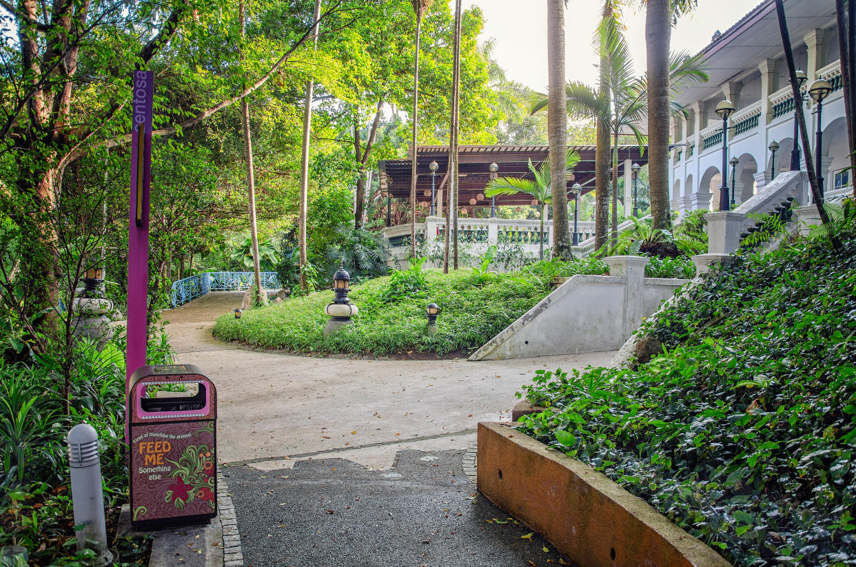 Singapore - March 24, 2018: A foot walk leads to the entrance staircase of the colonial building with arched basement and colonnade promenade on the first floor.