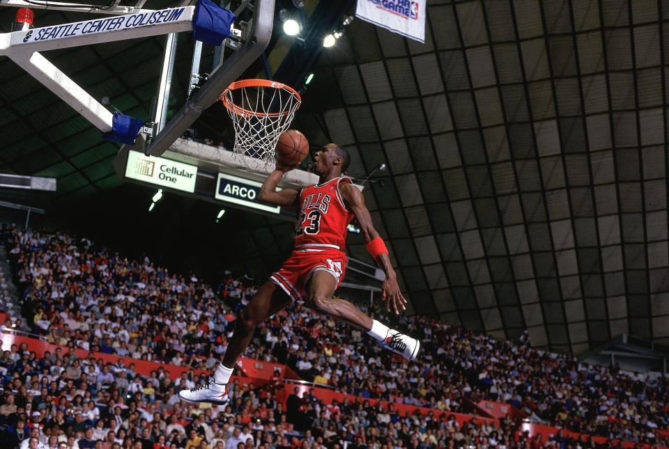 UNITED STATES - FEBRUARY 08: Basketball: NBA Slam Dunk Contest, Chicago Bulls Michael Jordan (23) in action, making dunk during All Star Weekend, Seattle, WA 2/8/1987 (Photo by Andy Hayt/Sports Illustrated via Getty Images) (SetNumber: X34346 TK2 R1)