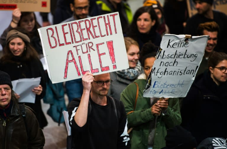 Germans held placards reading "Right to stay for all" and "No deportation to Afghanistan" as they demonstrated at Frankfurt airport, western Germany, on January 23, 2017