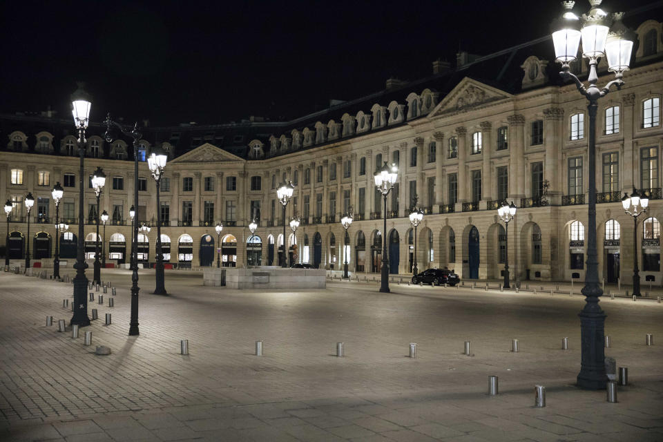 Vendome square is empty during curfew in Paris, Saturday, Oct. 17, 2020. French restaurants, cinemas and theaters are trying to figure out how to survive a new curfew aimed at stemming the flow of record new coronavirus infections. The monthlong curfew came into effect Friday at midnight, and France is deploying 12,000 extra police to enforce it. (AP Photo/Lewis Joly)