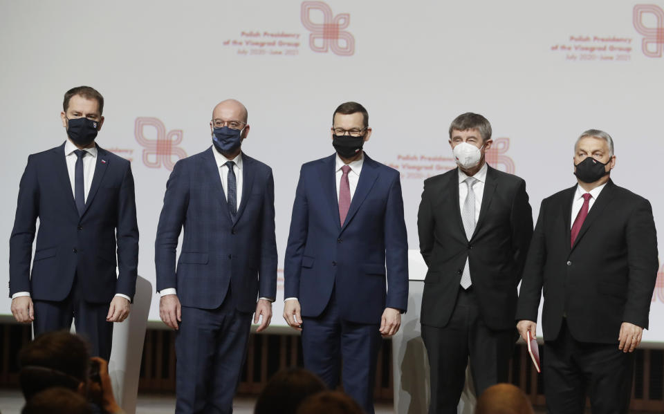 Prime ministers from central Europe Igor Matovic of Slovakia, left; Mateusz Morawiecki of Poland, center; The Czech Republic's Andrej Babis, second right and Viktor Orban of Hungary, right, with European Council President Charles Michel, second left, taking a family photo following a news conference at a meeting marking 30 years of central Europe's informal body of cooperation called the Visegrad Group, at a conference center in Krakow, Poland, Wednesday, Feb. 17, 2021.(AP Photo/Czarek Sokolowski)