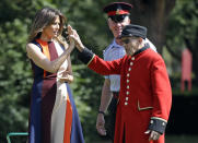 US First Lady Melania Trump, high-fives with a Chelsea Pensioner as she tries her hand at bowls during a visit to the Royal Hospital, Chelsea, London.