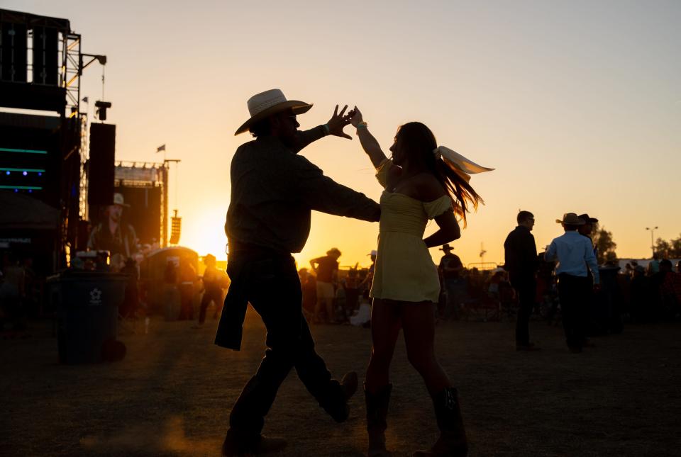 Julian Ballesteros and Kayley Gehrels dance during Jackson Dean's performance on the third day of Country Thunder in Florence on April 14, 2023.