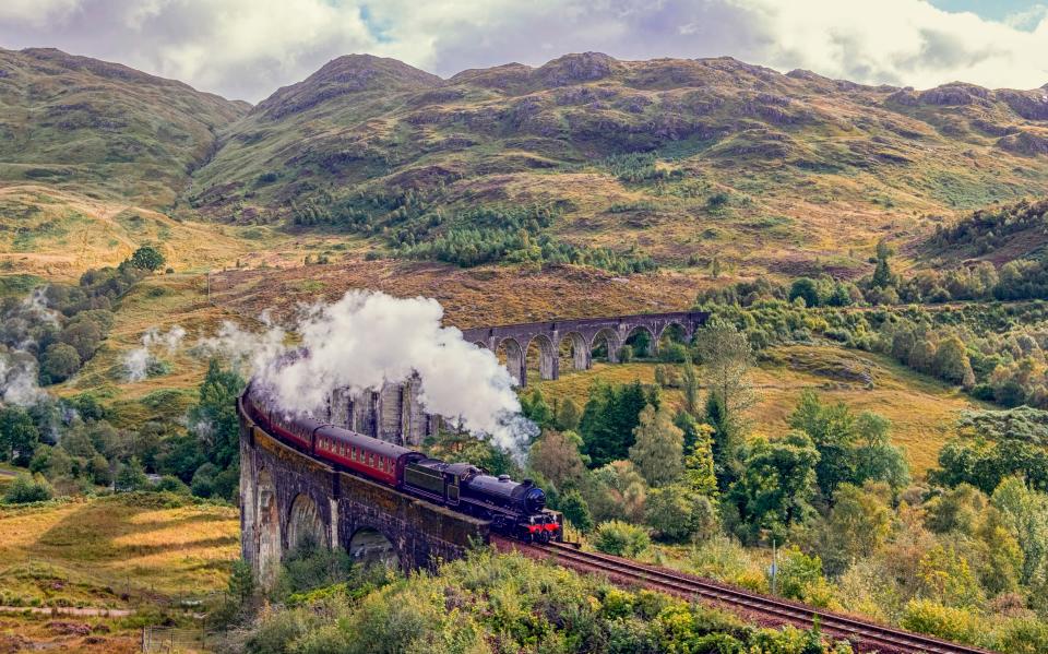 The Jacobite Steam Train ("Harry Potter train") crossing on Glenfinnan Viaduct, Scottish Highlands.