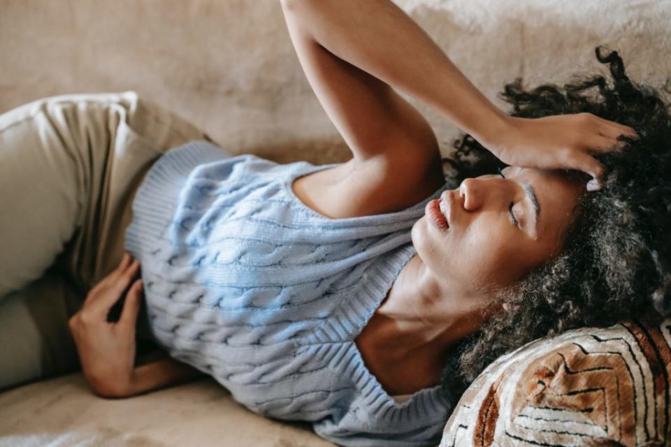 Upset Black woman laying on the couch