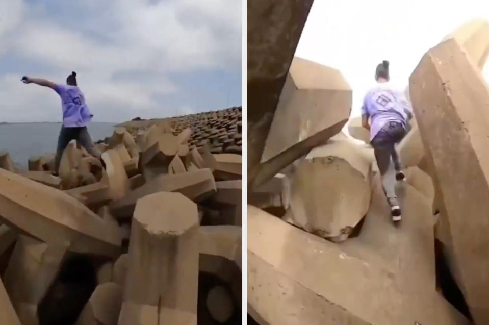 Person jumping between concrete blocks on a coastal defense structure