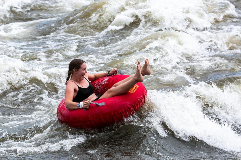 A cyclist cools off with a float down the Charles City whitewater course on the fifth day of RAGBRAI 2022.