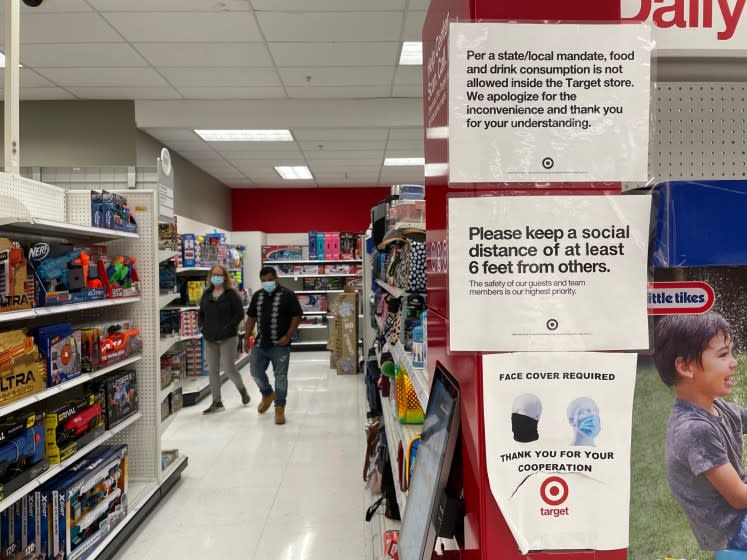 LOS ANGELES, CA - MAY 17: Signage inside Target reads that there is a mask mandate on the first day it has dropped the requirement for fully vaccinated customers, joining with Walmart, Trader Joes, Starbucks, Costco and other businesses in downtown on Monday, May 17, 2021 in Los Angeles, CA. (Dania Maxwell / Los Angeles Times)