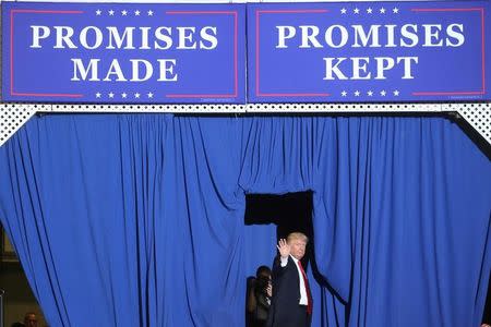 U.S. President Donald Trump waves on stage at a rally in Harrisburg, Pennsylvania, U.S. April 29, 2017. REUTERS/Carlo Allegri