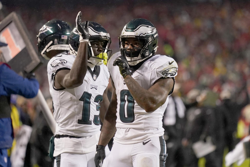 Philadelphia Eagles running back D'Andre Swift (0) is congratulated by teammate Olamide Zaccheaus (13) after scoring during the first half of an NFL football game against the Kansas City Chiefs, Monday, Nov. 20, 2023, in Kansas City, Mo. (AP Photo/Charlie Riedel)