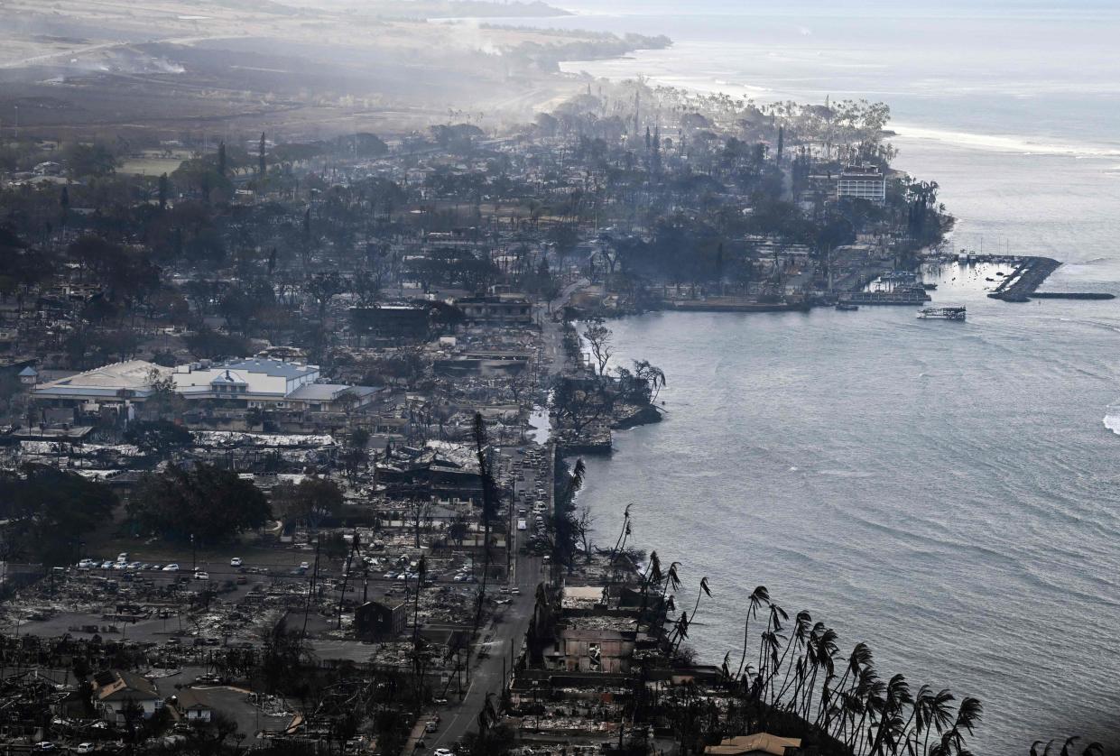 An aerial view shows destroyed homes and buildings that burned to the ground around the harbor and Front Street in the historic Lahaina Town (AFP via Getty Images)