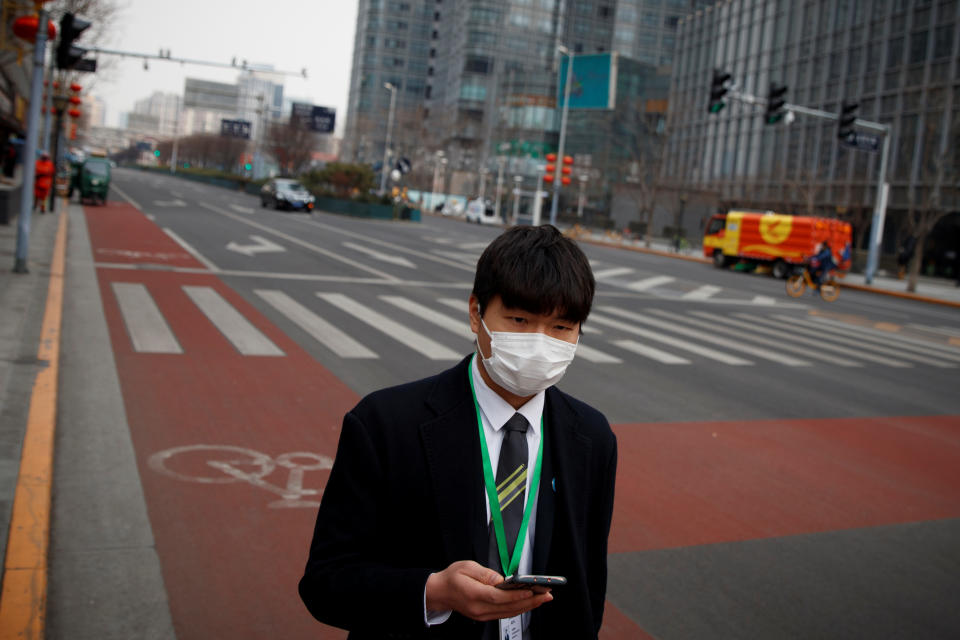 A businessman wears a face mask in the Central Business District in Beijing. Source: Reuters/Thomas Peter