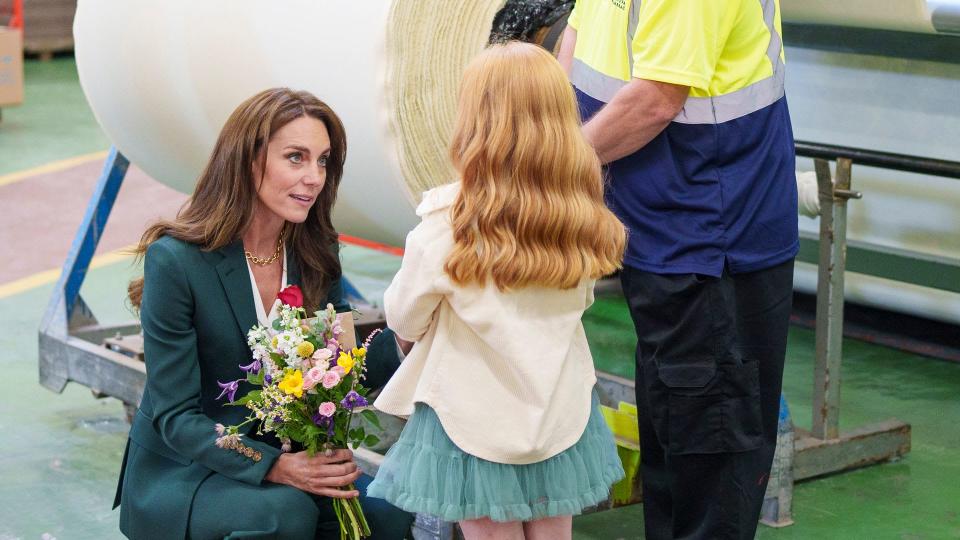 Kate Middleton receiving flowers and a card from a young girl