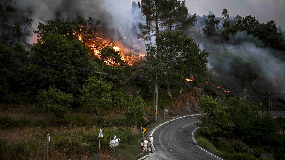 Wildfires are a problem in many parts of the world. Villagers watch the progression of a wildfire in Eiriz in the north of Portugal on July 15, 2022. - Patricia De Melo Moreira/AFP/Getty Images