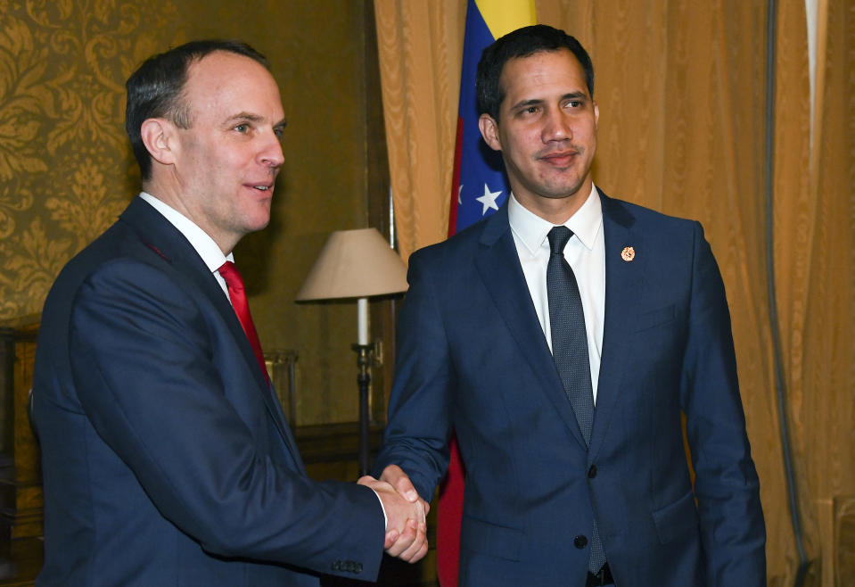 Venezuela's Opposition leader Juan Guaido, right, shakes hands with British Foreign Secretary Dominic Raab at Foreign Office in London, Tuesday, Jan. 21, 2020.(AP Photo/Alberto Pezzali)