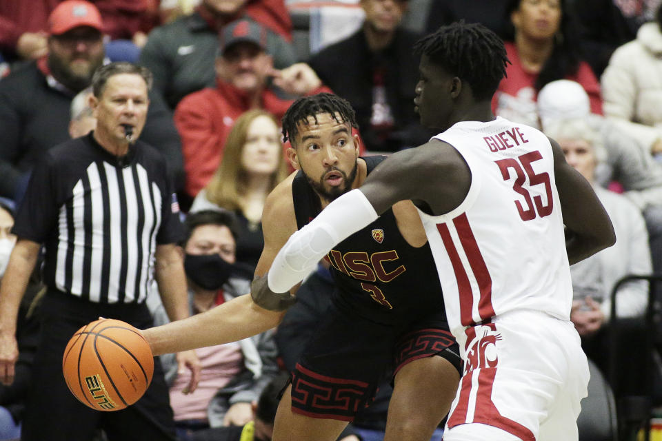 Southern California forward Isaiah Mobley (3) prepares to pass the ball while pressured by Washington State forward Mouhamed Gueye (35) during the first half of an NCAA college basketball game, Saturday, Dec. 4, 2021, in Pullman, Wash. (AP Photo/Young Kwak)