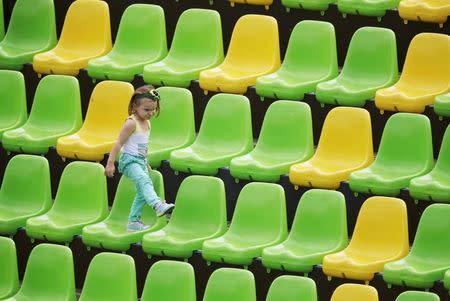 2016 Rio Olympics - Rugby - Women's Placing 11-12 Colombia v Kenya - Deodoro Stadium - Rio de Janeiro, Brazil - 08/08/2016. A child plays on empty seats at the stands. REUTERS/Phil Noble