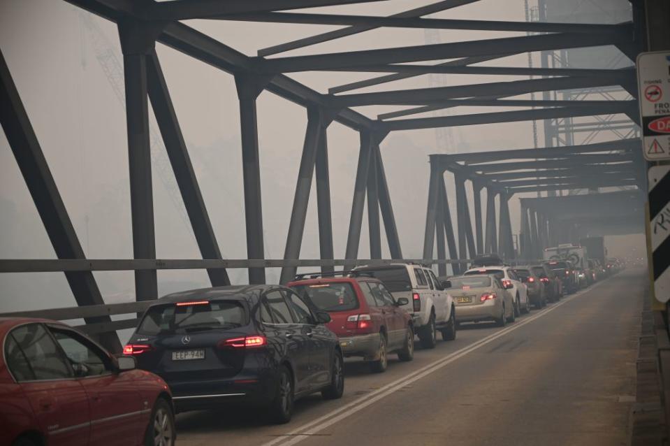 Cars on a bridge line up to leave Batemans Bay on Thursday amid bushfires.