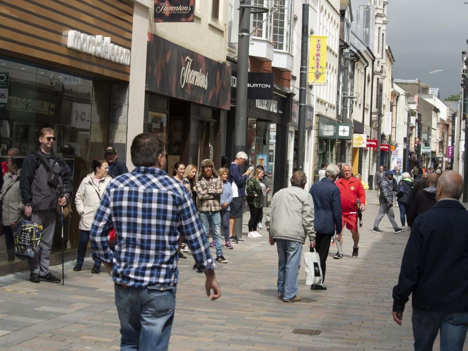 People shop in the high street as non-essential retail shops reopen in Douglas, Isle of Man, which began lifting Covid-19 lockdown restrictions on 24 April: Getty