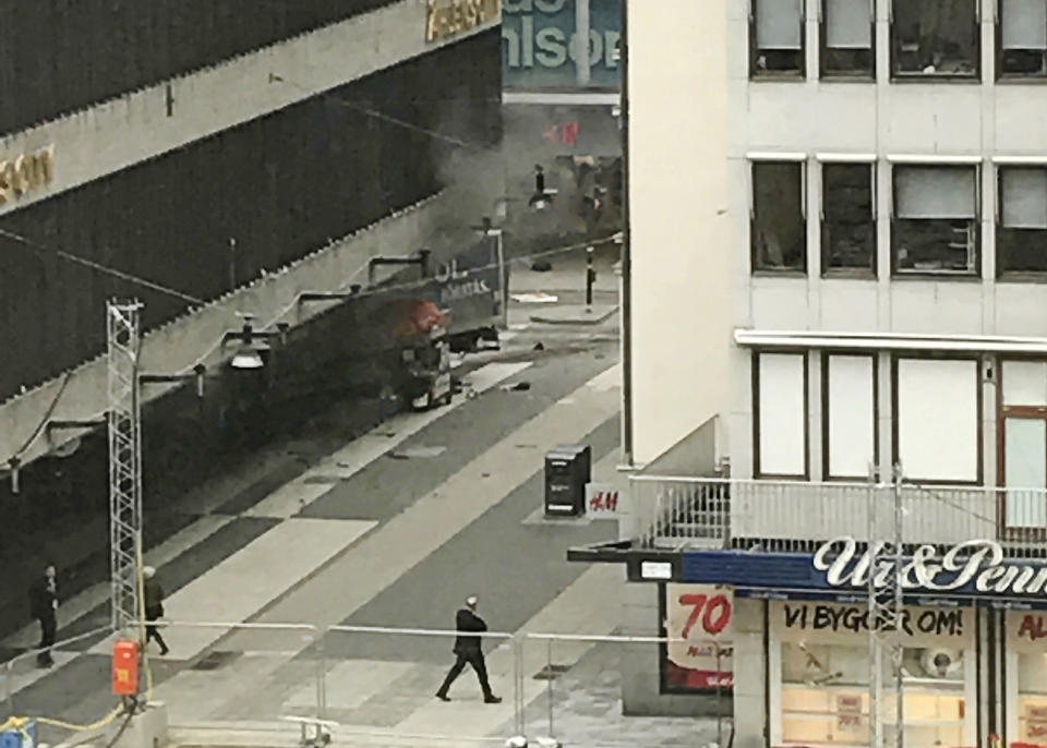 People look on at the scene after a truck crashed into a department store injuring several people in central Stockholm, Sweden, Friday April 7, 2017. (Andreas Schyman, TT News Agency via AP)