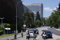 Bikes and cars stand in front of a traffic light near the Hotel Intecontinental in Geneva, Switzerland Monday, June 14, 2021. US President Joe Biden will sleep in the hotel ahead of the meeting with Russian President Vladimir Putin, which is scheduled for Wednesday, June 16, 2021 in Geneva. (AP Photo/Markus Schreiber)