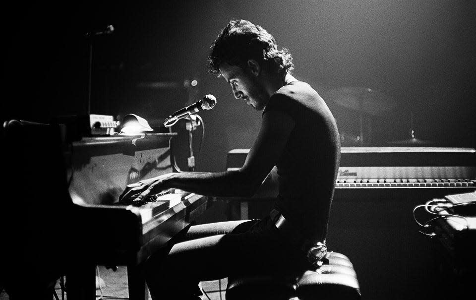 A photograph taken by Barry Schneier of Bruce Springsteen performing, "For You," on May 9, 1974 at the Harvard Square Theatre in Cambridge. [Photo courtesy of Barry Schneier]