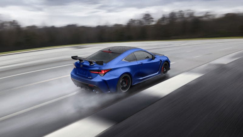 A photo of a blue Lexus RC-F driving on a track. 