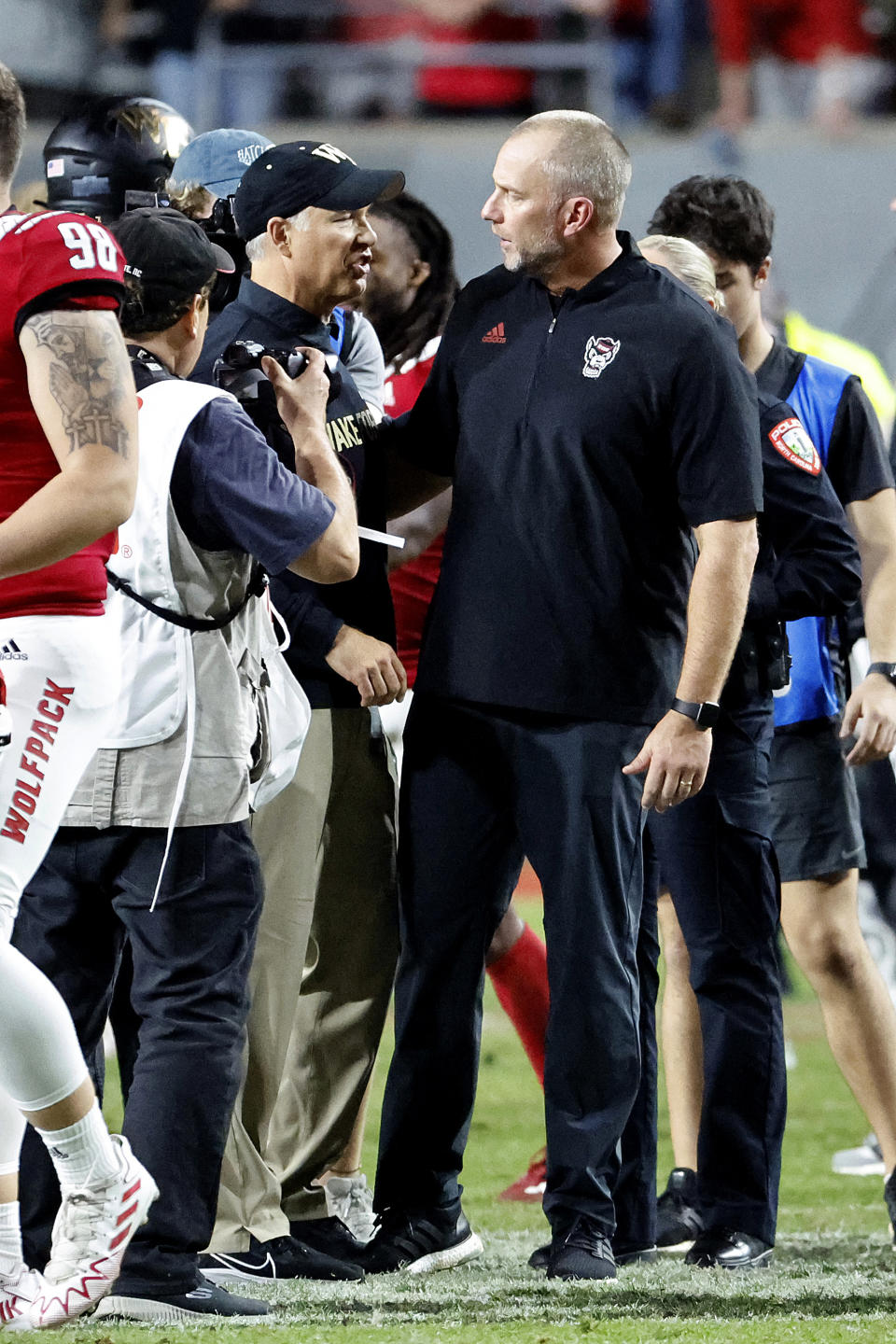 North Carolina State head coach Dave Doeren, right, speaks with Wake Forest head coach Dave Clawson following an NCAA college football game in Raleigh, N.C., Saturday, Nov. 5, 2022. (AP Photo/Karl B DeBlaker)