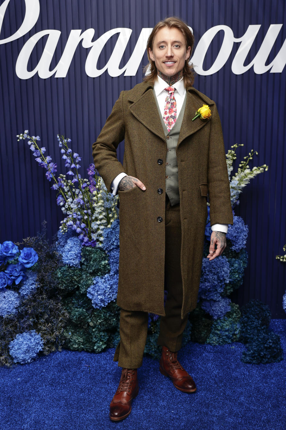 Ciarran Stott went for a brown ensemble, with an overcoat, matching pants, a grey waistcoat and floral tie. Photo: Getty