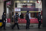 Police patrols in front of a building at the Davos Promenade with a slogan about AI alongside the World Economic Forum in Davos, Switzerland, Thursday, Jan. 18, 2024. The AI technology has taken a large and growing slice of attention in Davos, this year the theme of Artificial Intelligence "as a driving force for the economy and society" will get about 30 separate sessions. (AP Photo/Markus Schreiber)