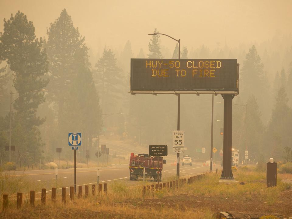 Sign stating highway is closed near Lake Tahoe amid air filled with smoke from Caldor Fire