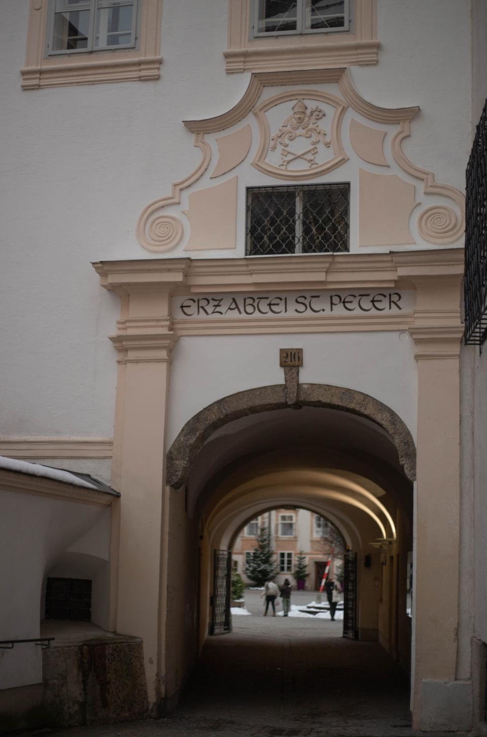 Exterior shot of an archway of a large pink and cream fortress.