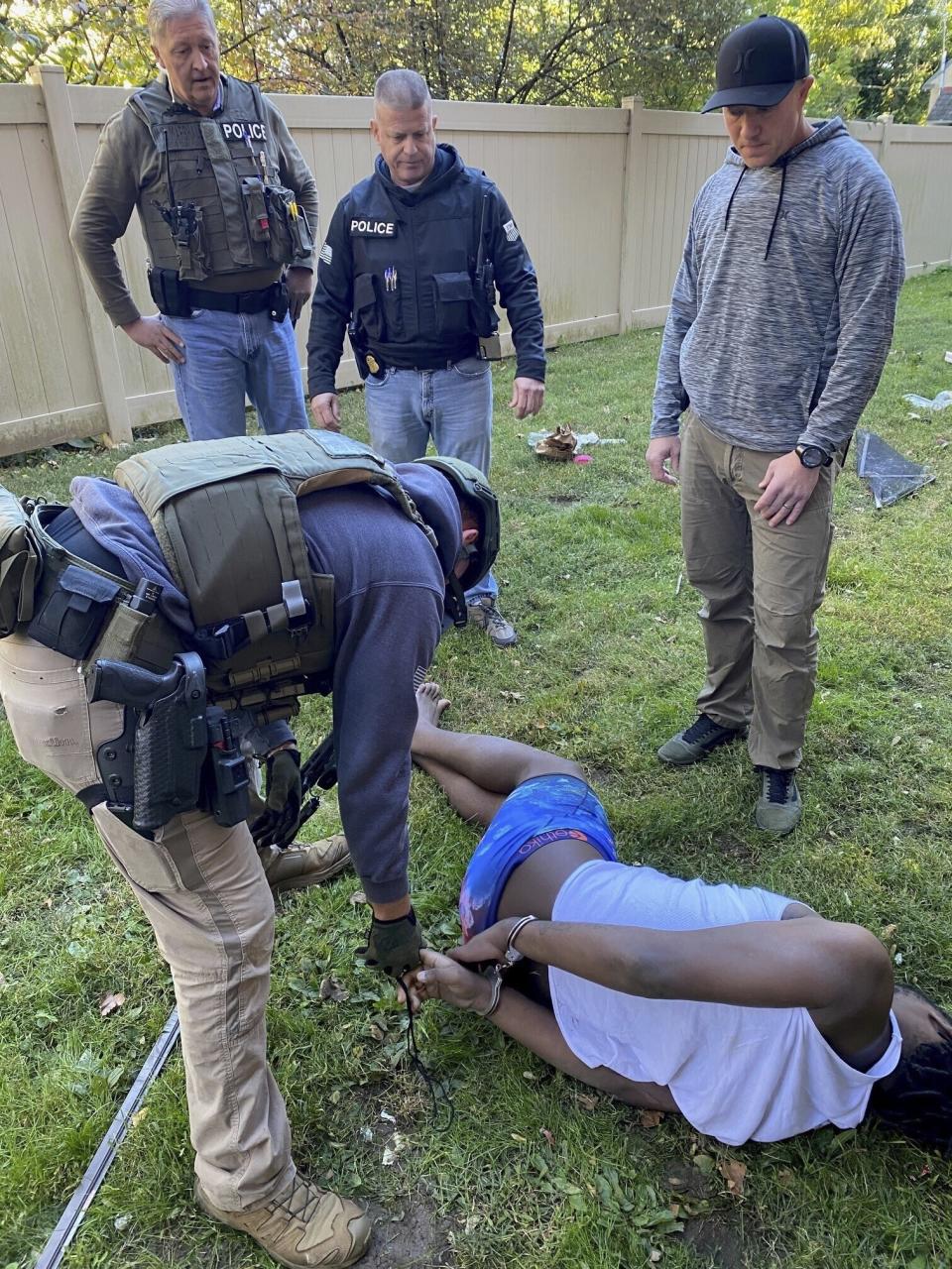 In this photo provided by the United States Marshals Service, marshals take Dayron Burney-Thorn into custody in Philadelphia's Germantown neighborhood on Monday, Oct. 23, 2023, after more than a year on the run. (United States Marshals Service via AP)