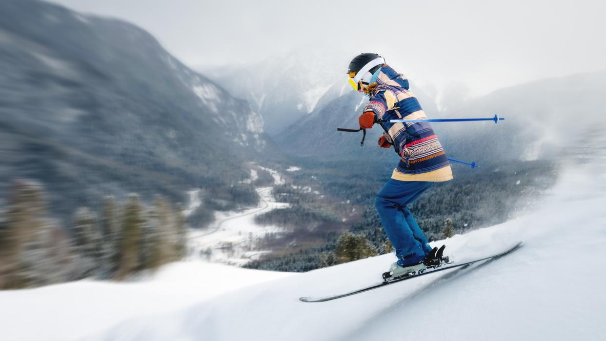  A female athlete skier rides a freeride in a winter forest in the mountains. 