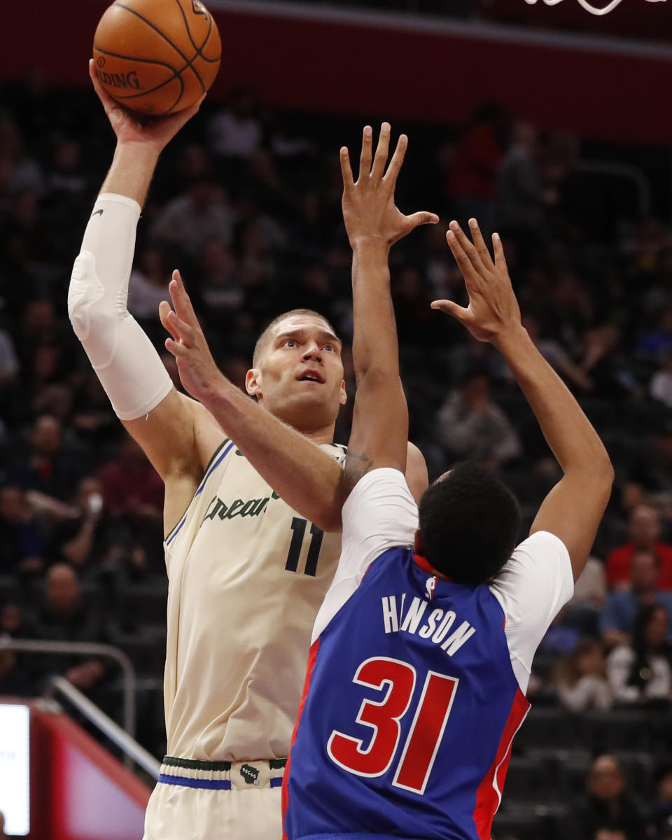 Milwaukee Bucks center Brook Lopez (11) shoots over Detroit Pistons forward John Henson (31) during the first half of an NBA basketball game, Thursday, Feb. 20, 2020, in Detroit. (AP Photo/Carlos Osorio)