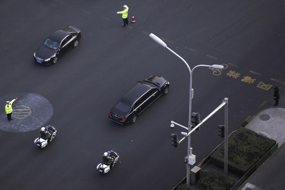 Traffic policemen direct traffic as a Mercedes limousine with a golden emblem, similar to one North Korean leader Kim Jong Un has used previously, is escorted by motorcades traveling past Chang'an Avenue in Beijing, Wednesday, Jan. 9, 2019. North Korean state media reported Tuesday that Kim is making a four-day trip to China in what's likely an effort by him to coordinate with his only major ally ahead of a summit with U.S. President Donald Trump that could happen early this year. (AP Photo/Andy Wong)